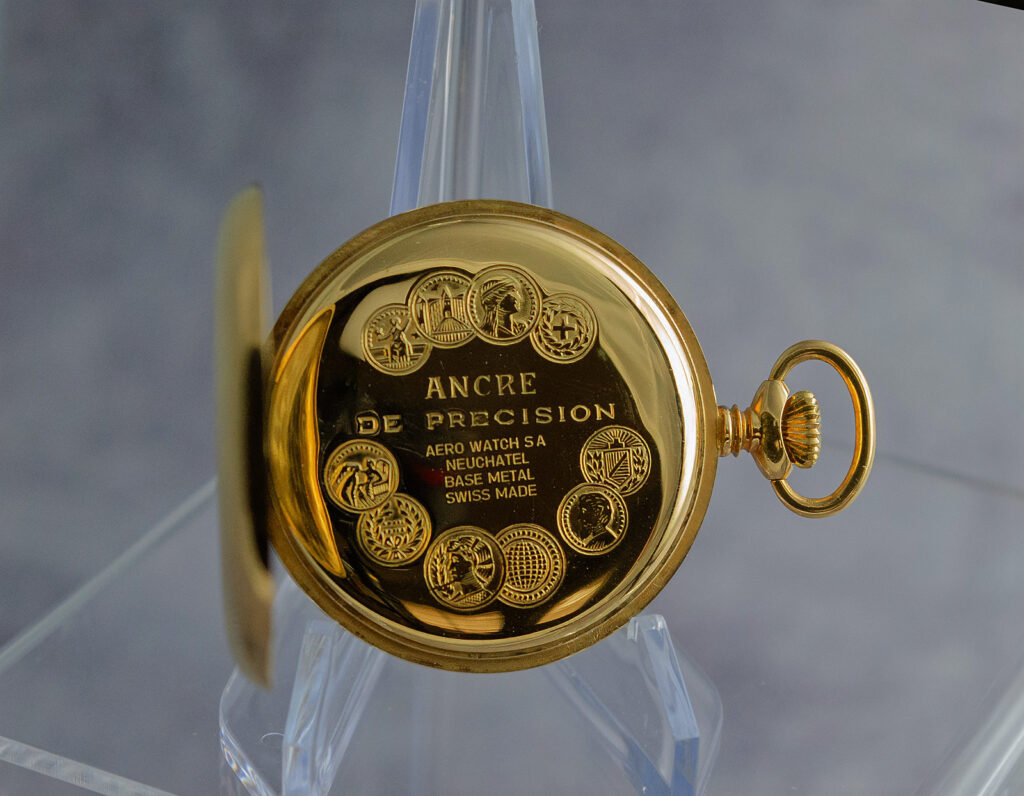 Inside view of the Arnex 14G’s back cover showing inscriptions: "ANCRE DE PRECISION" and "15 RUBIS" with floral engraving.