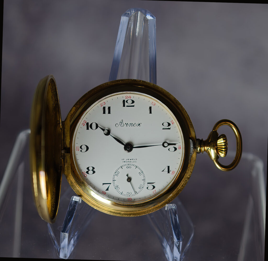 Close-up of the Arnex 14G pocket watch dial in near mint condition, showing crisp numerals and gold-plated case—part of a US Watch Masters restoration.