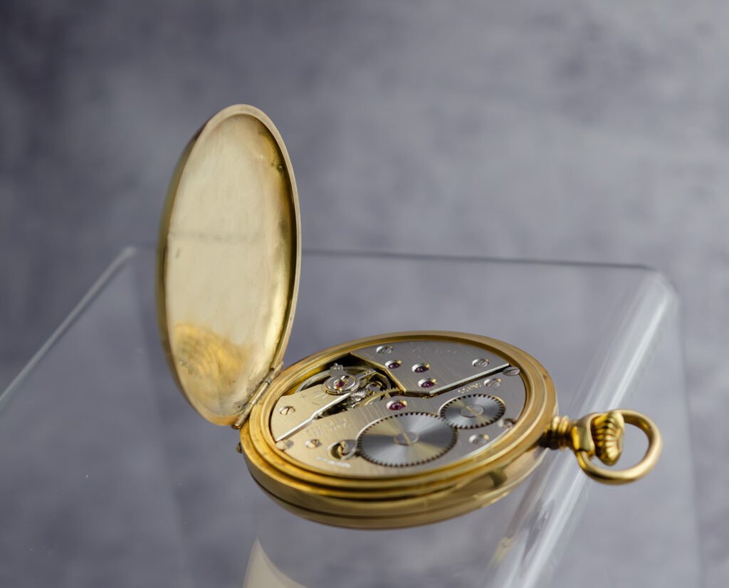 View of the Arnex 14G pocket watch movement with the back cover open, revealing the Unitas 6498 mechanism.